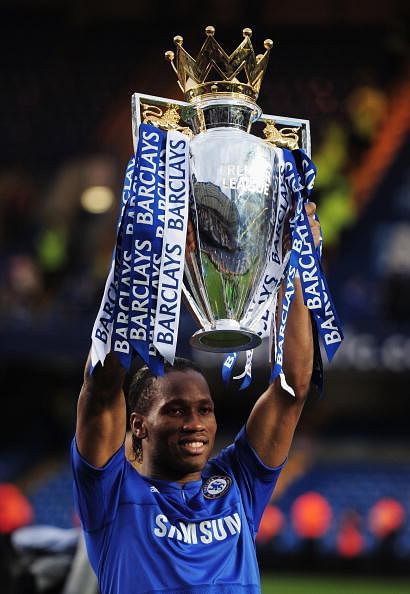 Didier Drogba of Chelsea celebrates with the trophy as they win the title after the Barclays Premier League match between Chelsea and Wigan Athletic at Stamford Bridge on May 9, 2010 in London, England. Chelsea won 8-0 to win the championship. (Photo by Shaun Botterill/Getty Images)
